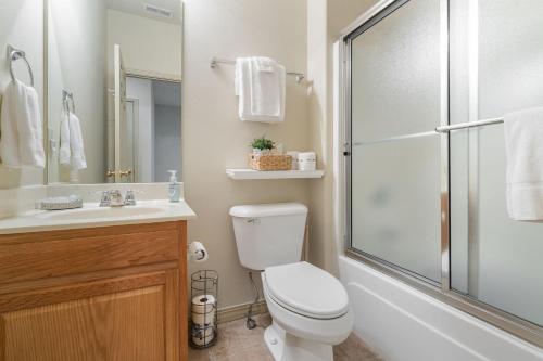 a bathroom with a shower and a toilet and a sink at The Gathering Place - Minutes to 61-Acre Theme Park in Branson West