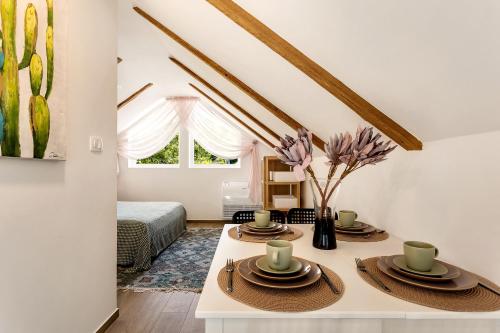 a room with a table with hats and flowers on it at Mirola homes - rent in nature in Zagorje ob Savi