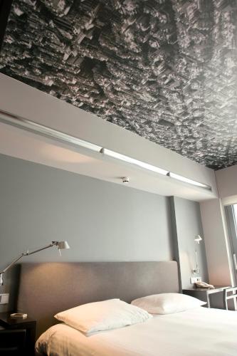 a bedroom with a bed and a painting on the ceiling at Periscope in Athens