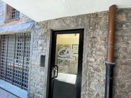 a door to a building with a stone wall at Appartamento fronte mare in Portovenere