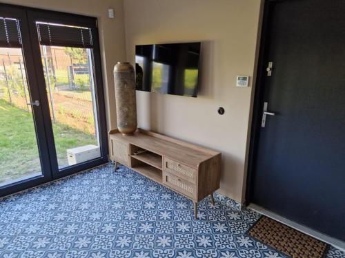 a room with a wooden dresser and a mirror at La Jura in Podlesice