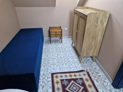 a bedroom with a bed and a dresser and a rug at La Jura in Podlesice