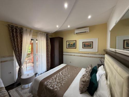 a bedroom with a large bed and a window at Grand Apartments Scepanovic in Tivat