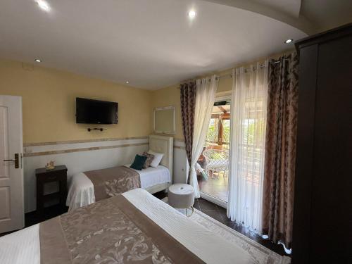 a hotel room with two beds and a window at Grand Apartments Scepanovic in Tivat