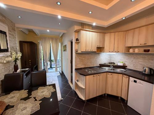 a kitchen with wooden cabinets and a sink at Grand Apartments Scepanovic in Tivat