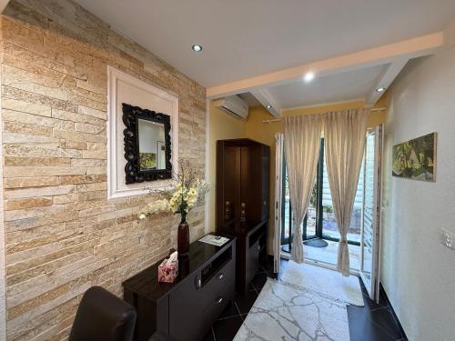 a living room with a brick wall at Grand Apartments Scepanovic in Tivat