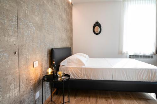 a bedroom with a bed and a side table at Villa Tosati in Monza