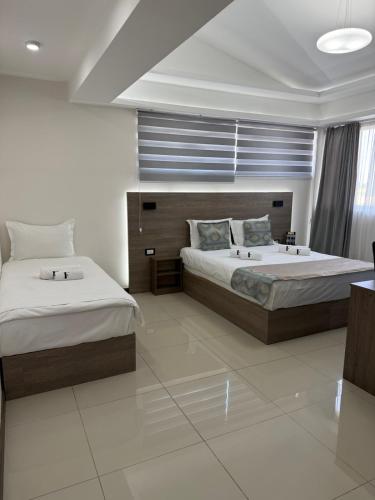 a bedroom with two beds and a window at ForS Konak Apartments in Belgrade
