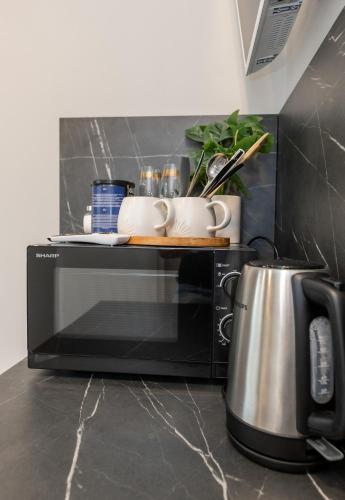 a black microwave with a tray on top of it at Miniukas in Kaunas