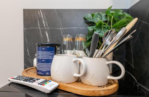 a table with two coffee cups and a remote control at Miniukas in Kaunas