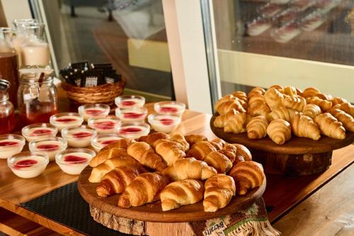 two plates of croissants and other pastries on a table at Hotel Han Bjelašnica in Bjelašnica