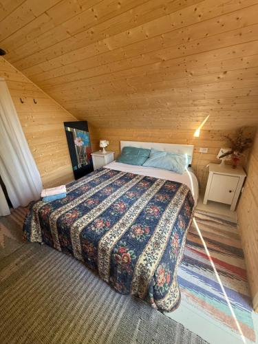 a bedroom with a bed in a wooden cabin at Il Pruno - Exclusive Tent in San Giuliano Terme