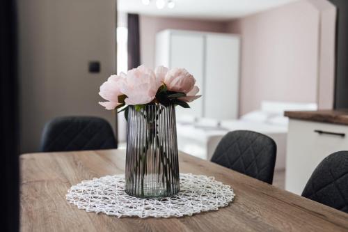 a vase of pink flowers sitting on a table at Hrisi&Kris in Sapareva Banya