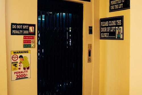 a door in a room with signs on it at Sacred Stay in Guwahati