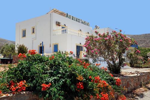 a white building with flowers in front of it at Aeriko Hotel Apartments in Arvanitochori