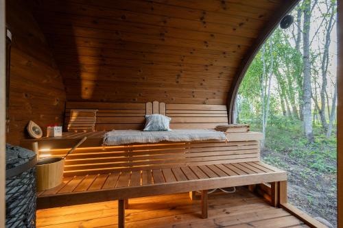 a sauna in a wooden cabin with a window at Luigepesa Puhkemaja - Swan Nest dome house with sauna and pond in Järtsaare