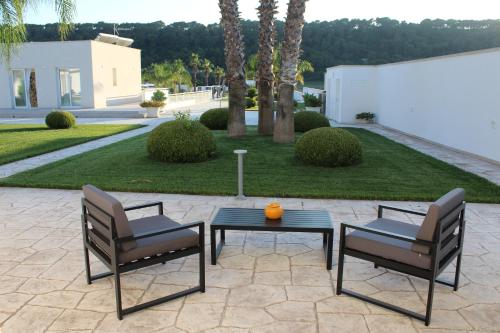 two chairs and a table on a patio at Dani's residence in Supersano