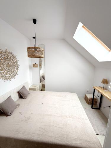a white room with a large bed in it at Apartament Szyszka 2 in Rogowo