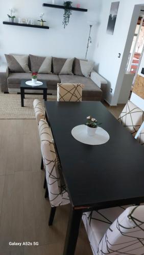 a black table and chairs in a living room at Anno Apartman in Balatonföldvár