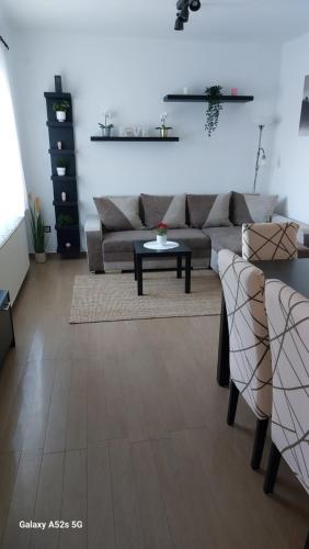 a living room with a couch and a table at Anno Apartman in Balatonföldvár