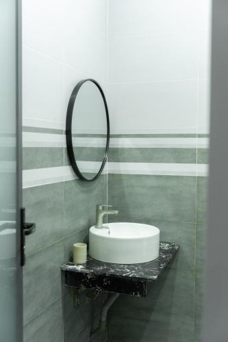 a bathroom with a sink and a mirror at Nami Homestay in Bao Loc