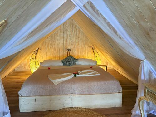 a bedroom with a bed in a tent at Mr Kahawa in Paje