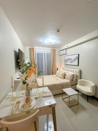 a large living room with a bed and a couch at The Cozy Clouds Staycation in Suba