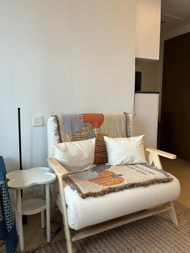 a couch with pillows and a chair in a room at Prince Edward, 1 mins dining & transportation in Hong Kong