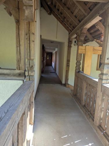 an empty hallway in an old building with a wooden ceiling at Vila Bârsana in Bîrsana