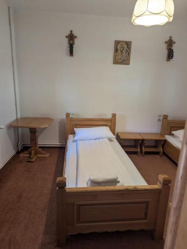 a bedroom with a bed and a cross on the wall at Vila Bârsana in Bîrsana