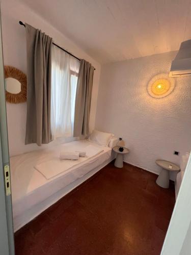 a room with a bed with a window and two toilets at Gioma Garden Villas in Istron