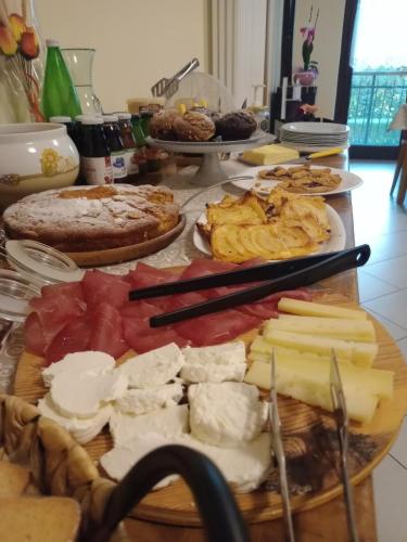 a table with cheese and other foods on it at Alloggio del contadino in Sondrio
