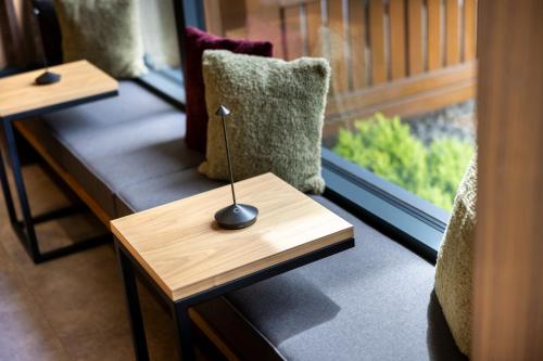 a wooden table with a small lamp on top of a couch at Hotel Gesser in Sillian