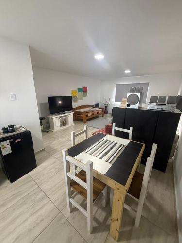 a living room with a wooden table and chairs at Amanecer Rio Limay in Plottier