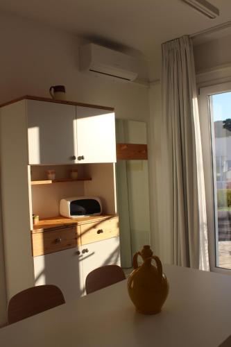 a kitchen with a table with chairs and a kitchenestamp at Dani's residence in Supersano