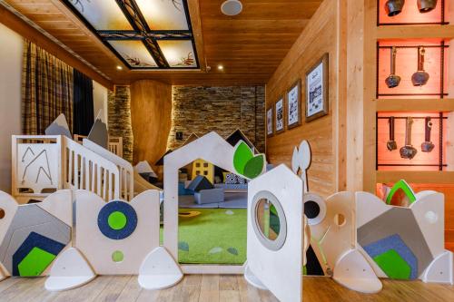 a childrens room with a play area with wooden walls at Hotel Bania Thermal & Ski in Białka Tatrzanska