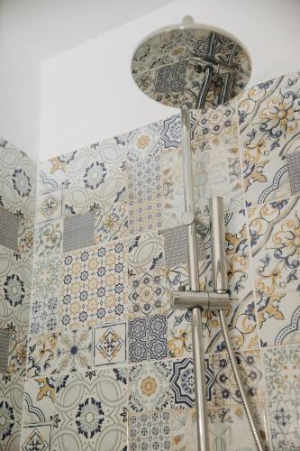 a room with a wall with tiles on the wall at Agriturismo I Millepini in Case Malva