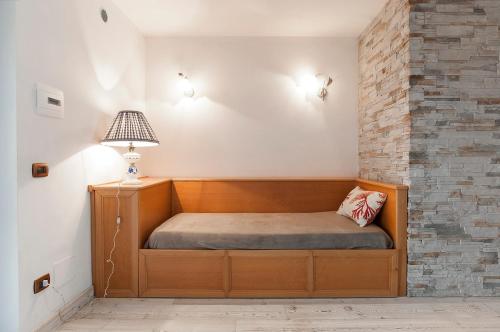 a bed in a room with a brick wall at Villa Afrodite in Mondragone