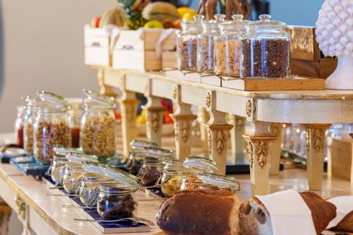a long table with jars of food and bread at Manzi Hotel & Spa in Ischia