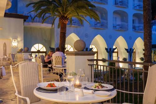 a restaurant with a table with plates of food on it at Manzi Hotel & Spa in Ischia