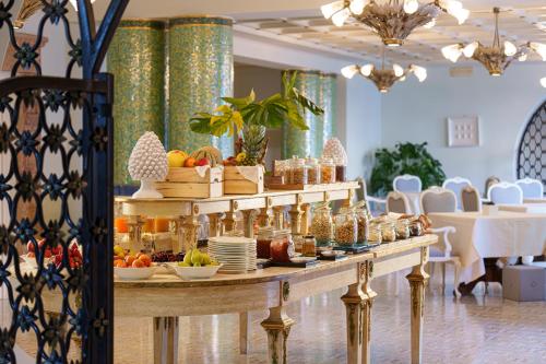 a buffet line with food on a table in a restaurant at Manzi Hotel & Spa in Ischia