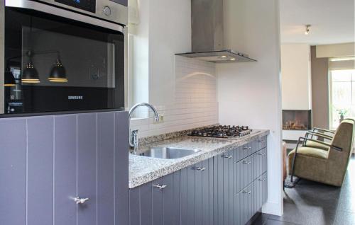 a kitchen with a sink and a stove at Buitengoed Het Lageveld - 108 in Hoge-Hexel