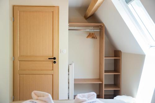 a room with a closet with a door and a staircase at Les Granges du Hautacam in Artalens-Souin