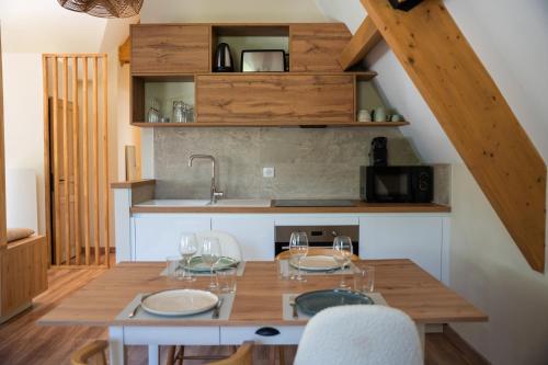 a kitchen with a table with chairs and a sink at Les Granges du Hautacam in Artalens-Souin