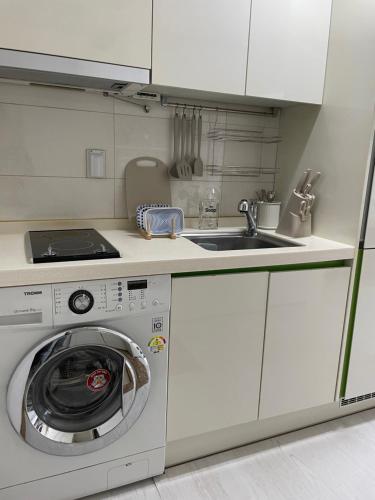 a kitchen with a washing machine and a sink at Gangnam Cozy home 7 min to subway in Seoul