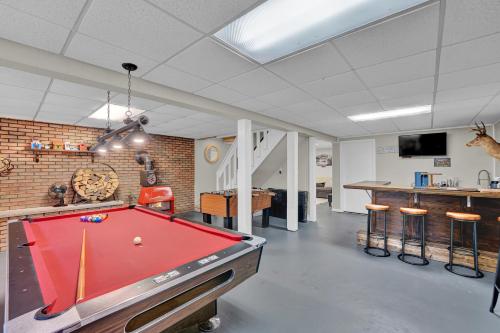 a room with a pool table and a bar at Liambear's Den in Lake Ariel