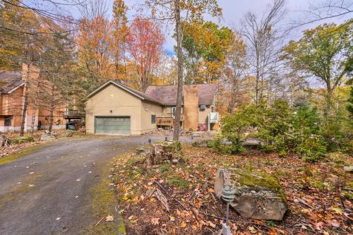 a house in the woods with a driveway at Liambear's Den in Lake Ariel