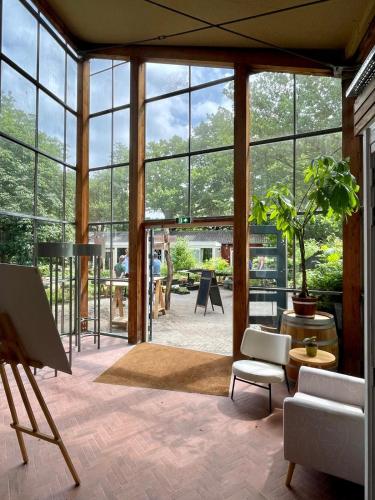 a living room with a large glass wall at Plaats De Kleine Aarde in Boxtel