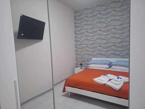 una camera da letto con un letto con asciugamani sopra di Machi House a Scafati