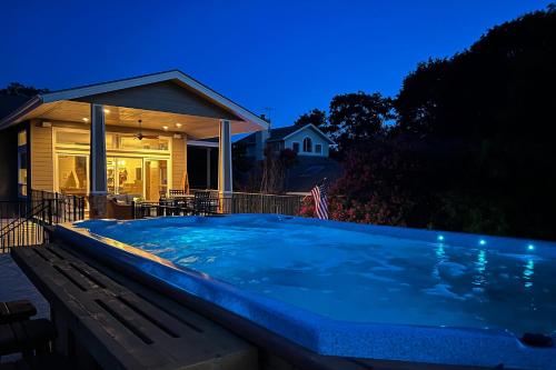 a hot tub in front of a house at night at Paradise Cove in Granite Shoals